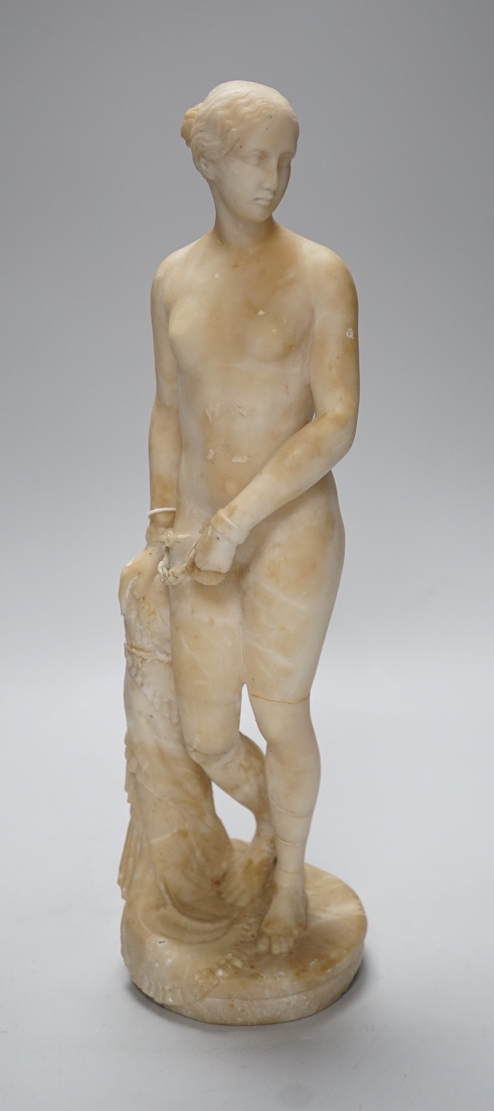 A carved alabaster female classical figure, the Greek slave Hiram Powers, 36cms high